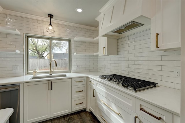 kitchen featuring white cabinets, decorative light fixtures, custom exhaust hood, and sink