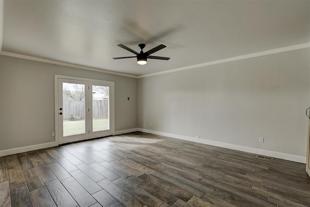 empty room with ceiling fan, ornamental molding, and dark wood-type flooring