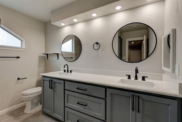 bathroom featuring tile patterned flooring, vanity, and toilet