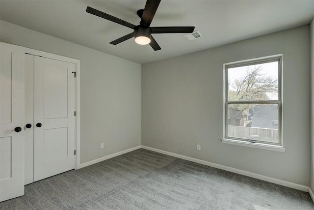 unfurnished bedroom with ceiling fan, light colored carpet, and a closet