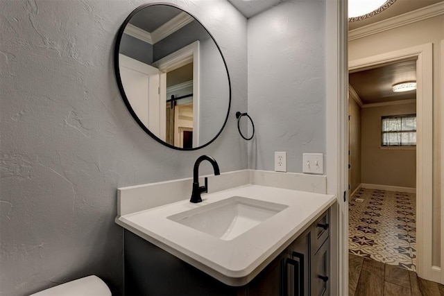 bathroom featuring wood-type flooring, vanity, and crown molding