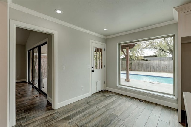 interior space with light wood-type flooring and ornamental molding