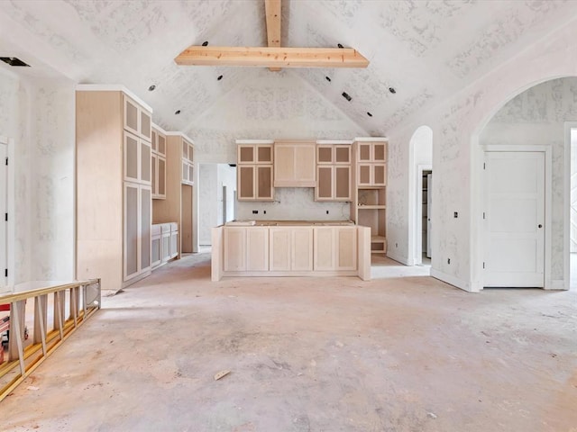 unfurnished living room with high vaulted ceiling