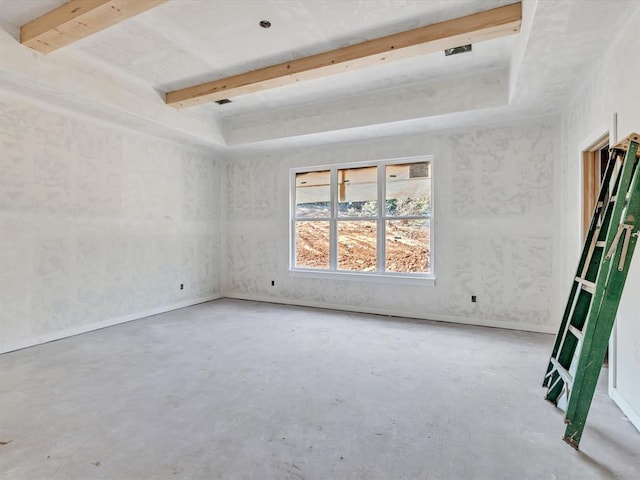 empty room featuring beam ceiling and concrete floors