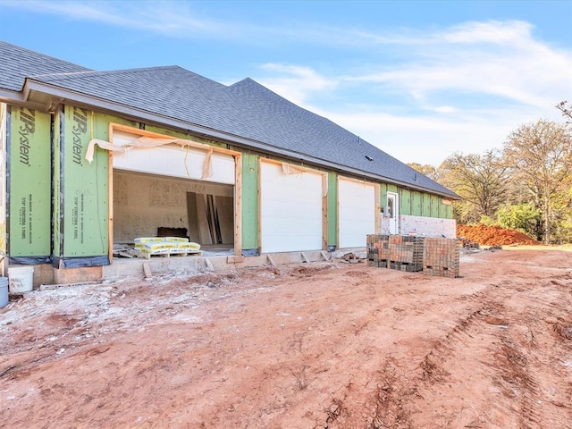 rear view of house with a garage