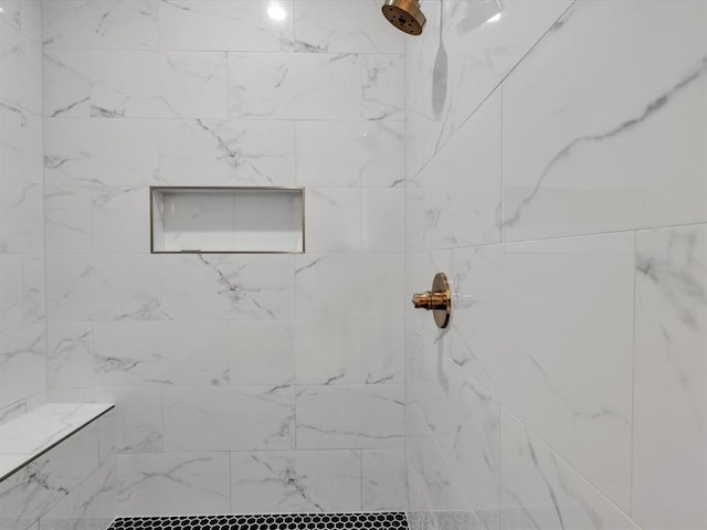 full bath featuring a tile shower