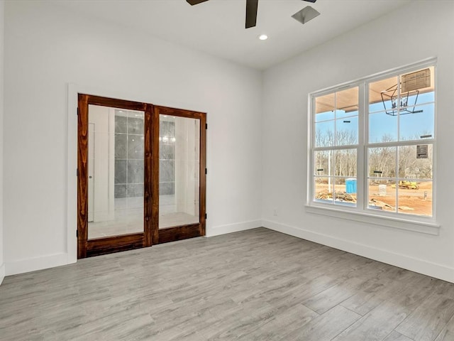 unfurnished room with french doors, baseboards, and wood finished floors