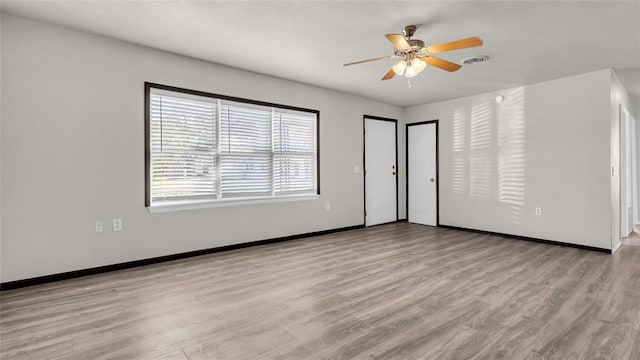 unfurnished room featuring light wood-type flooring and ceiling fan