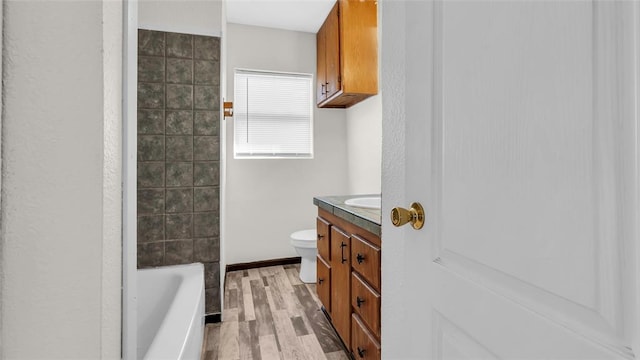 full bathroom with vanity, wood-type flooring, bathtub / shower combination, and toilet