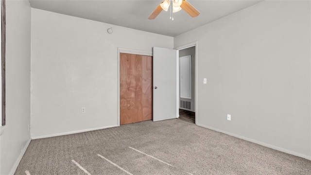 unfurnished bedroom featuring ceiling fan and carpet floors