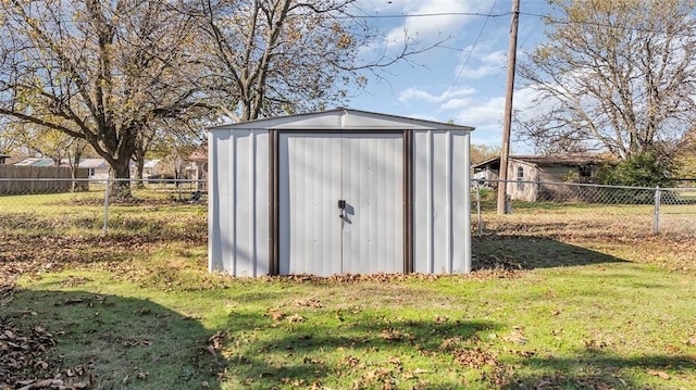 view of outbuilding with a yard