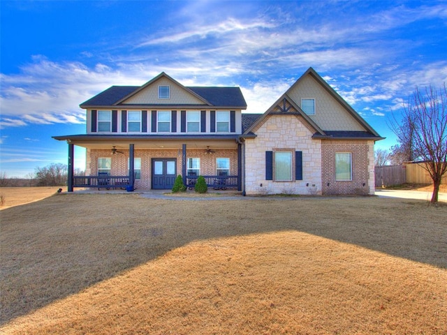 craftsman inspired home featuring ceiling fan, a porch, and a front yard