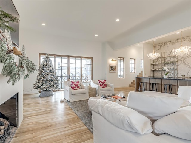 living room with a fireplace and light wood-type flooring