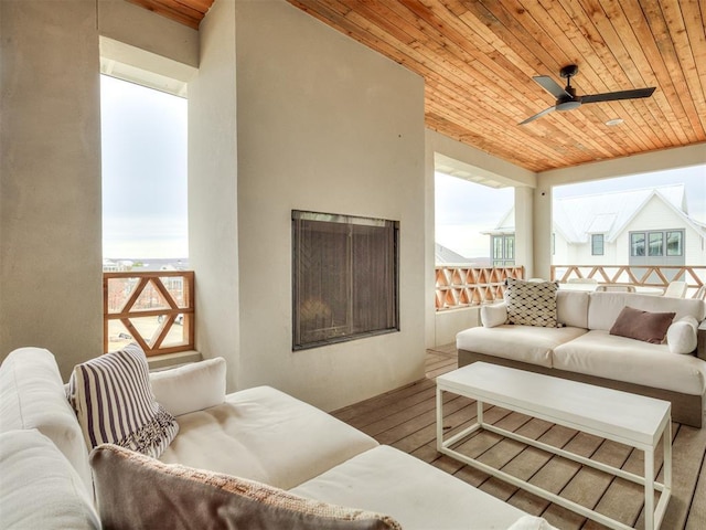 living room with ceiling fan, hardwood / wood-style floors, and wood ceiling