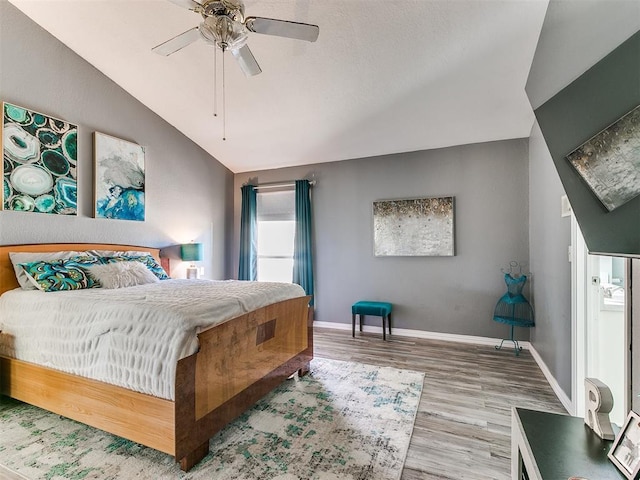 bedroom featuring ceiling fan, vaulted ceiling, and hardwood / wood-style flooring