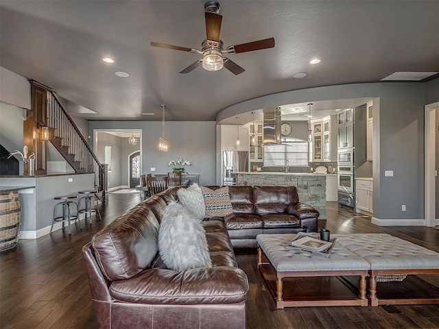 living room featuring ceiling fan, dark wood-type flooring, and sink