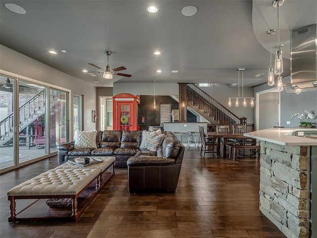 living room featuring dark hardwood / wood-style floors and ceiling fan
