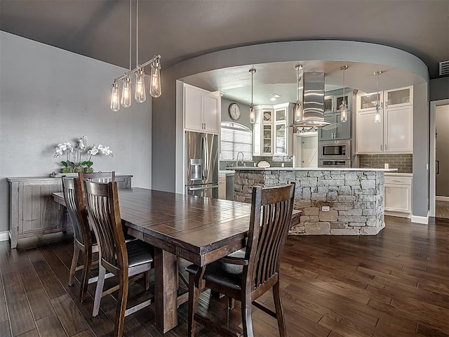 dining area with dark hardwood / wood-style flooring and sink