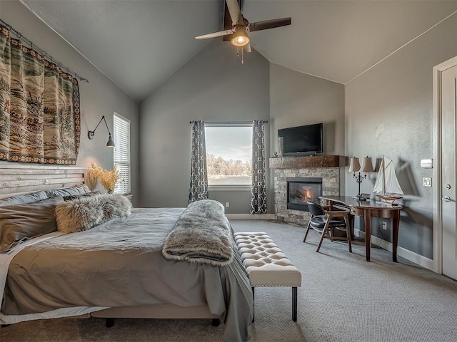 carpeted bedroom featuring a fireplace, vaulted ceiling, and ceiling fan