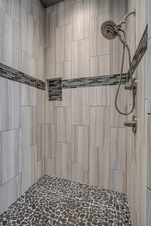 bathroom with a tile shower