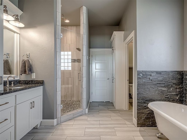 bathroom featuring vanity and shower with separate bathtub