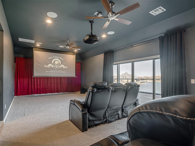 carpeted home theater room with ceiling fan