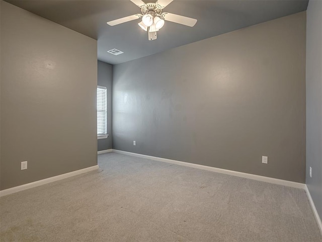 empty room featuring ceiling fan and light colored carpet