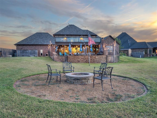 yard at dusk with a balcony and a fire pit