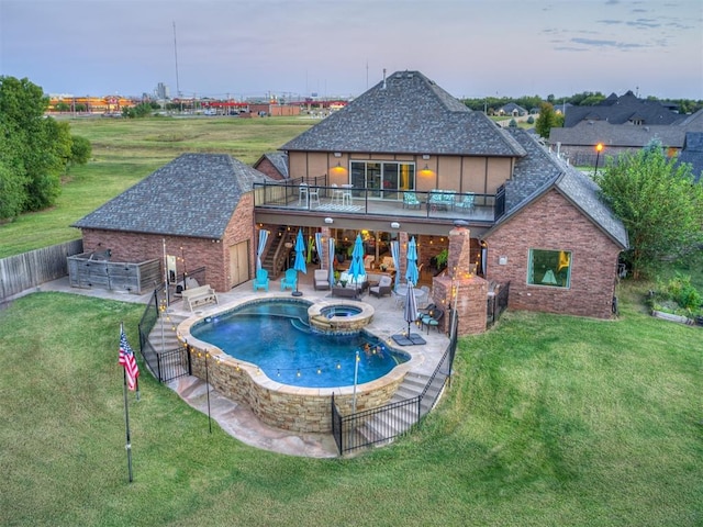 view of swimming pool with an in ground hot tub, a yard, a patio, and an outdoor hangout area