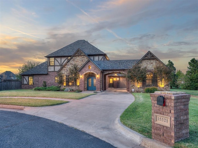 tudor home featuring a lawn