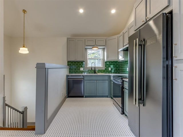 kitchen with gray cabinetry, sink, decorative light fixtures, and appliances with stainless steel finishes