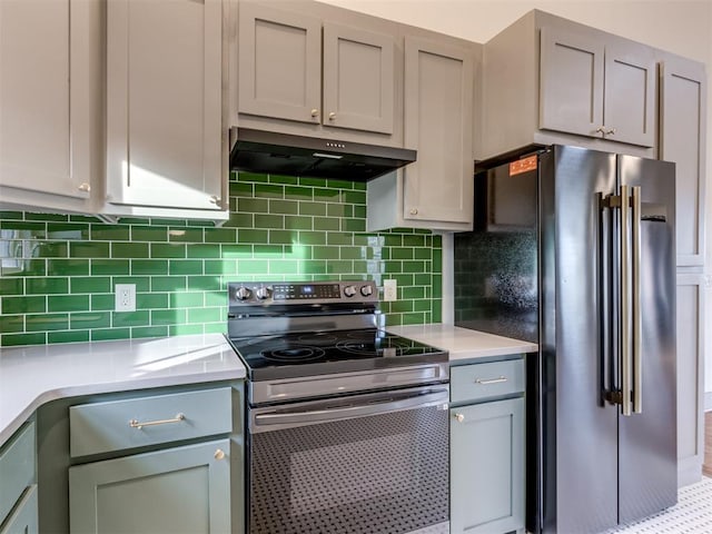 kitchen featuring gray cabinetry, decorative backsplash, and stainless steel appliances