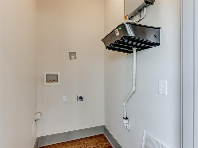 clothes washing area featuring electric dryer hookup, hookup for a washing machine, and hardwood / wood-style floors