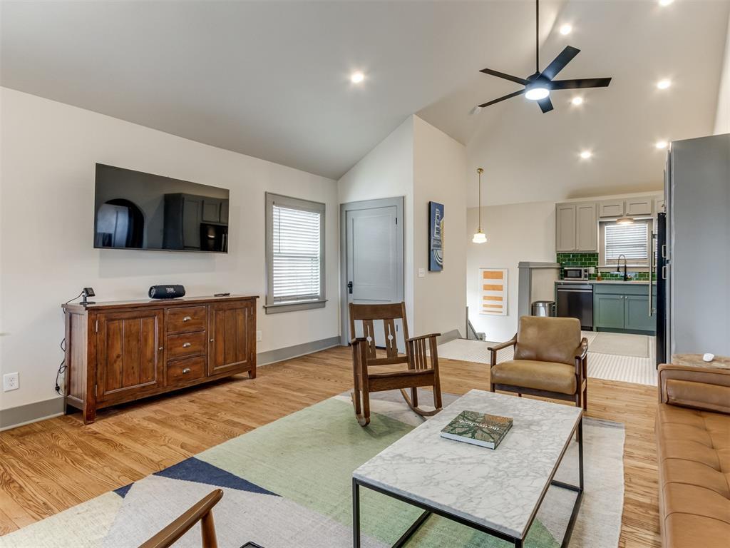 3309 N Walker Ave, Oklahoma City, OK 73118 - living area featuring light wood finished floors, baseboards, high vaulted ceiling, and ceiling fan