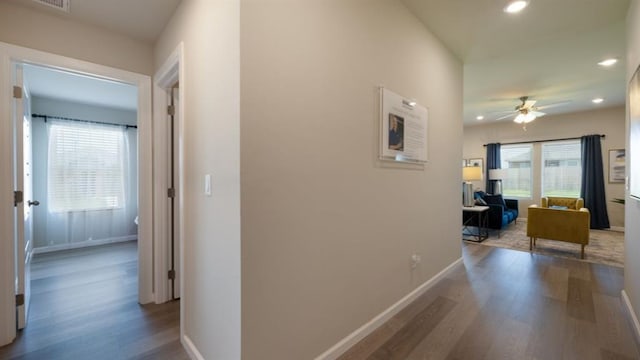 hall with recessed lighting, wood finished floors, and baseboards