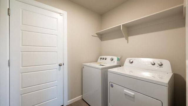 laundry area featuring laundry area, independent washer and dryer, and baseboards