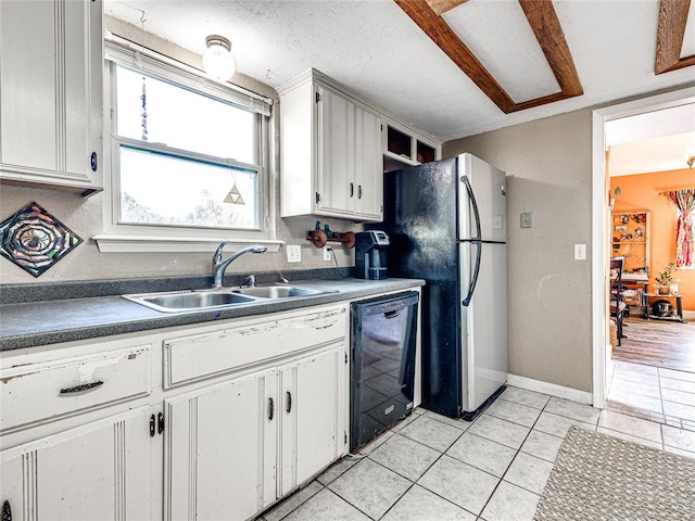 kitchen with white cabinetry, sink, stainless steel refrigerator, and dishwasher