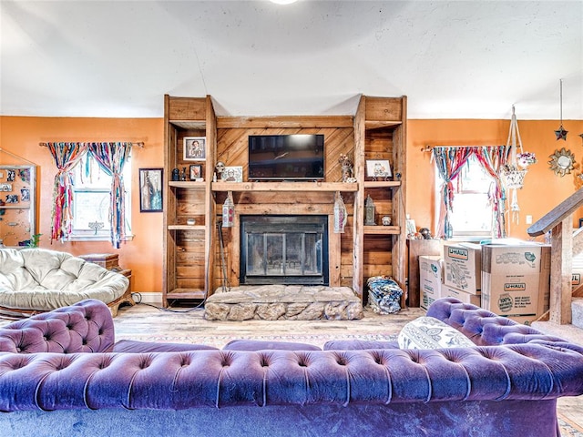 living room featuring a stone fireplace