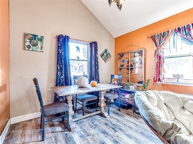 dining area featuring vaulted ceiling and hardwood / wood-style floors