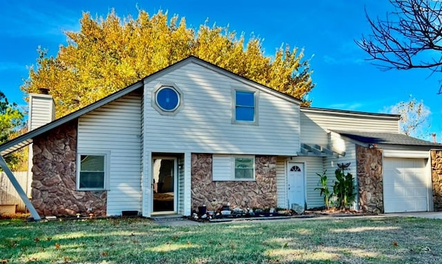 view of front of house with a garage and a front yard