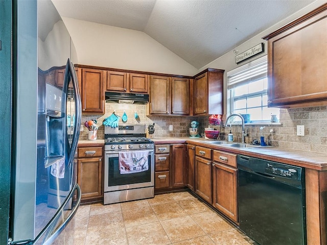 kitchen with black appliances, backsplash, lofted ceiling, and sink