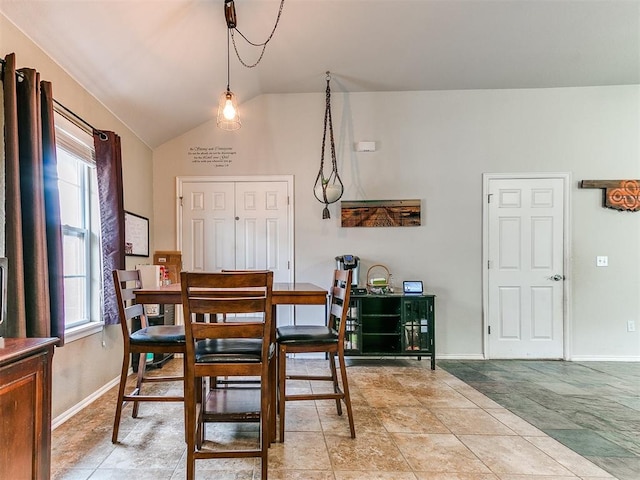 dining space with a healthy amount of sunlight and vaulted ceiling