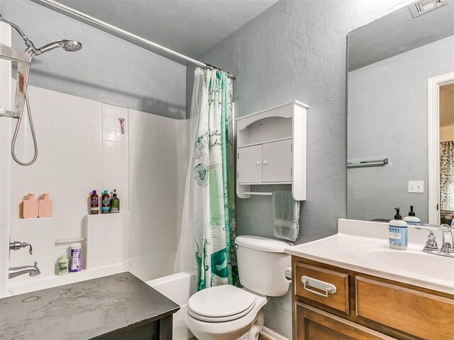 full bathroom with vanity, shower / bathtub combination with curtain, and toilet