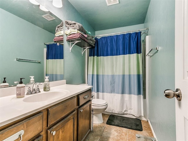 full bathroom with vanity, shower / bath combo, and toilet