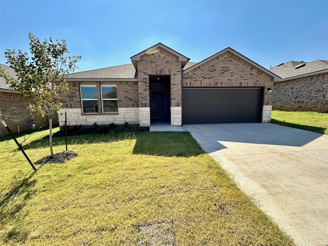 view of front of property with a garage and a front yard