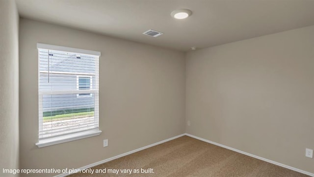 spare room featuring baseboards, visible vents, and carpet flooring