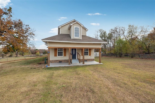 view of front of home with a patio and a front lawn