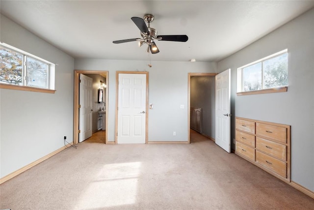 unfurnished bedroom with ceiling fan, light carpet, and connected bathroom