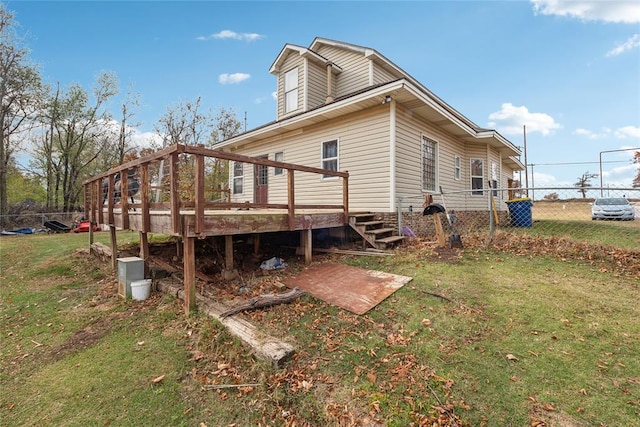 back of house with a lawn and a deck