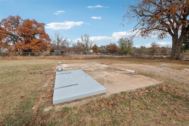 view of storm shelter with a yard and a rural view